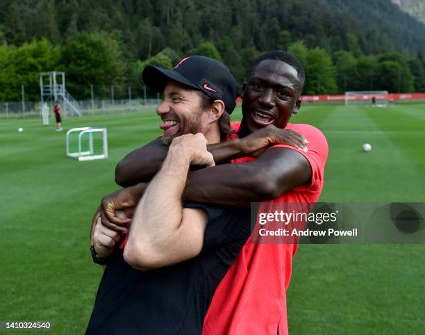 Ibrahima Konate of Liverpool with Andreas Kornmayer Head of fitness and conditioning at Liverpool during a training session at the Liverpool...