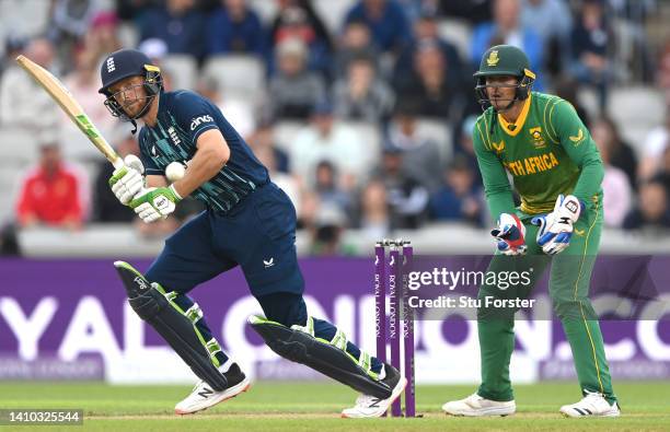 England batsman Jos Buttler hits out watched by Quinton de Kock during the 2nd ODI between England and South Africa at Emirates Old Trafford on July...