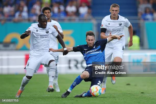 Matthias Bader of Darmstadt is challenged by Christian Kinsombi of Sandhausen during the Second Bundesliga match between SV Darmstadt 98 and SV...
