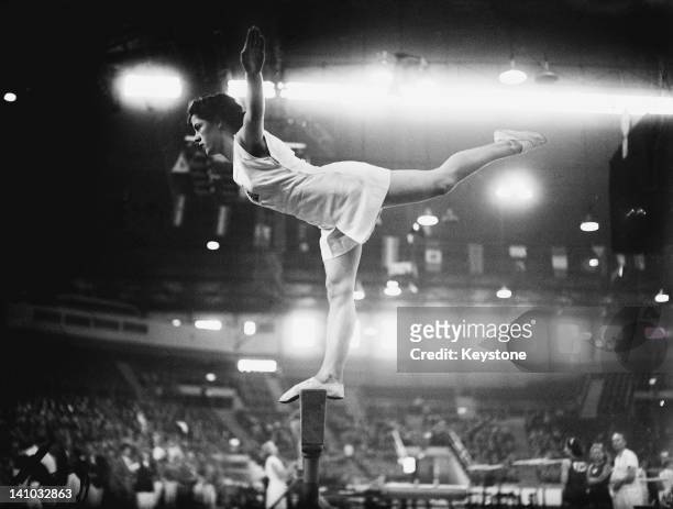 Cissie Davies of Great Britain on the balance beam at Empress Hall, Earl's Court, during the gymnastics events at the London Olympic Games, 12th...
