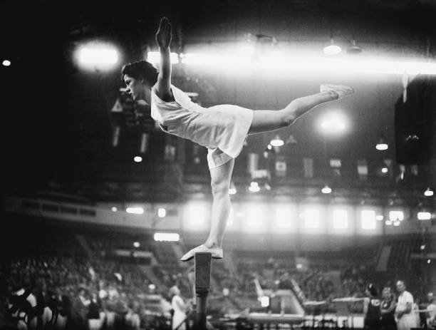 Cissie Davies of Great Britain on the balance beam at Empress Hall, Earl's Court, during the gymnastics events at the London Olympic Games, 12th...