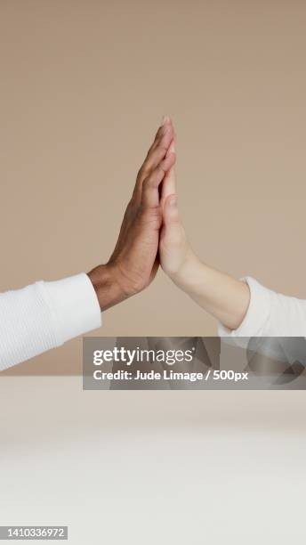 cropped hands of couple holding hands against wall,miami,florida,united states,usa - limage stock pictures, royalty-free photos & images