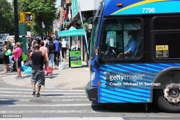 An MTA bus driver waits to turn into Flatbush Avenue on July 22, 2022 in the Flatbush neighborhood of the Brooklyn borough in New York City. A heat...