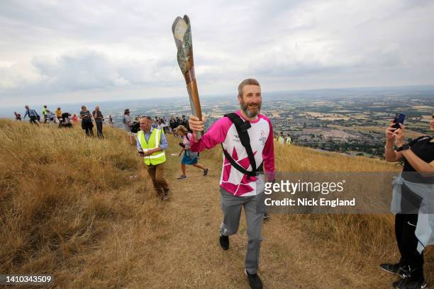 Batonbearer Marcus Mumford holds the Queen's Baton at the top of the Worcester Beacon during the Birmingham 2022 Queen's Baton Relay on July 22...