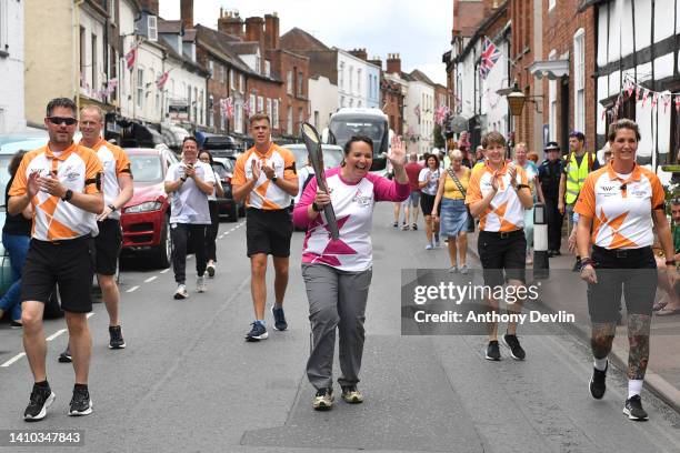 Baton bearer Elisabeth Ransted carries the Queen's Baton during the Birmingham 2022 Queen's Baton Relay during a visit to Upton upon Severn town...