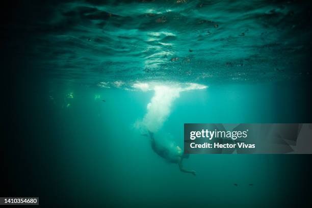 Tourist dives into the Oxman cenote on July 16, 2022 in Valladolid, Mexico. The Yucatan Peninsula has the world's largest underwater cave system,...