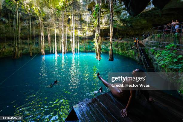 Tourist sunbathes at the Oxman cenote on July 16, 2022 in Valladolid, Mexico. The Yucatan Peninsula has the world's largest underwater cave system,...