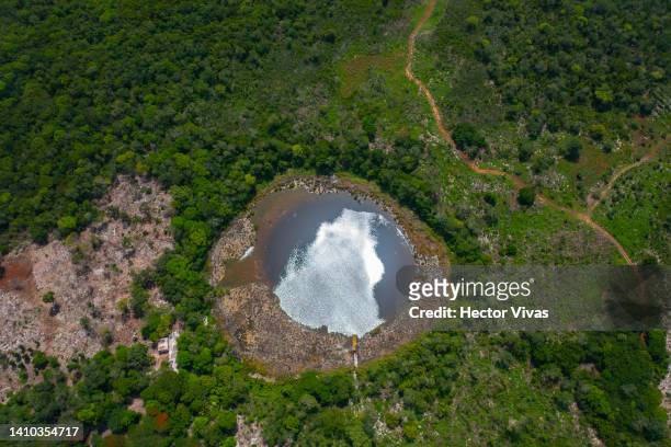 Aerial view of an open-air cenote located lees than two kilometers away from industrial pig and poultry farms on July 15, 2022 in Muna, Mexico. The...