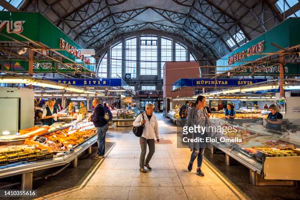 sellers and customers in riga central market, latvia - riga stockfoto's en -beelden