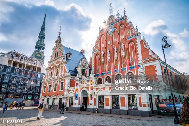 view of the old town ratslaukums square, roland statue, the blackheads house near st peters cathedral against blue sky in riga, latvia. summer sunny day - riga latvia stock pictures, royalty-free photos & images
