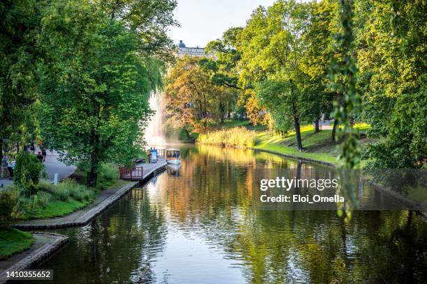 boat on a canal in kronvalda park of riga. latvia - baltic countries stock pictures, royalty-free photos & images