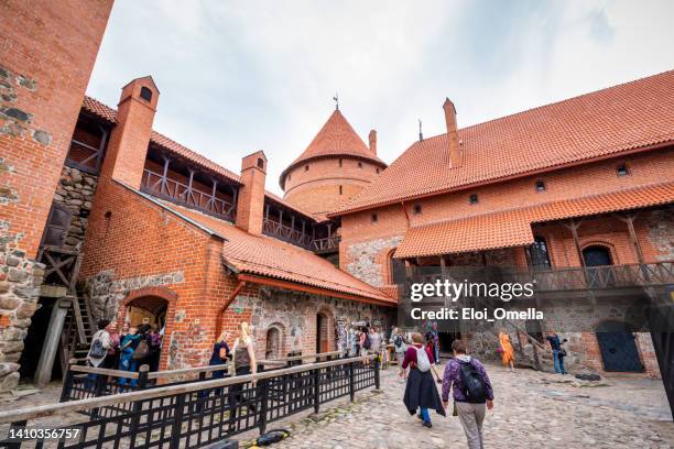 tourists in front of trakai castle in lithuania - vilnius stock pictures, royalty-free photos & images