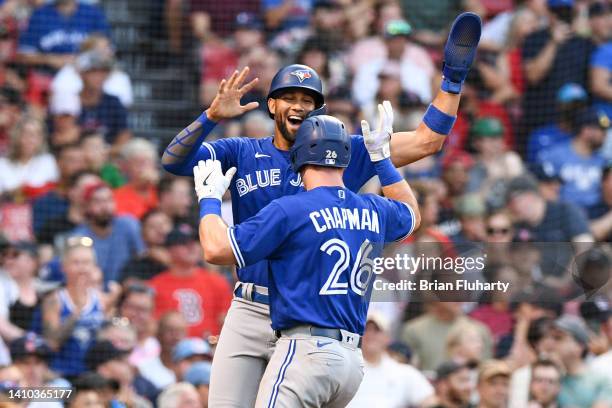 Matt Chapman of the Toronto Blue Jays celebrates with Lourdes Gurriel Jr. #13 after hitting a two-run home run against the Boston Red Sox during the...