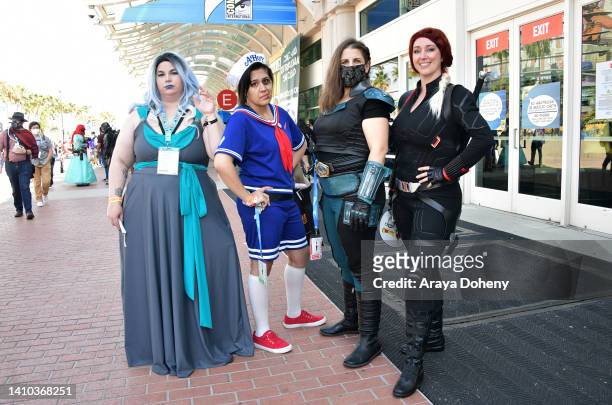 Cosplayers dressed as Hades, Steve from Stranger Things, Carasynthia "Cara" Dune and Black Widow costumes at the 2022 Comic-Con International: San...