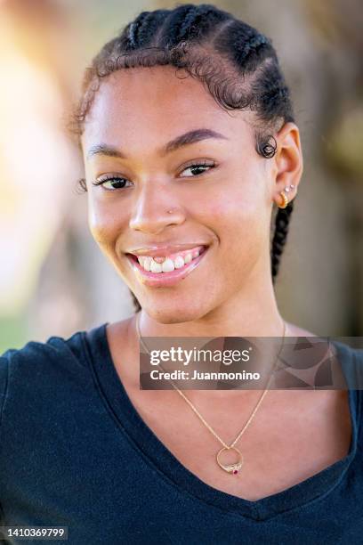 smiling afro-latinx young woman looking at the camera - teen lesbians stock pictures, royalty-free photos & images