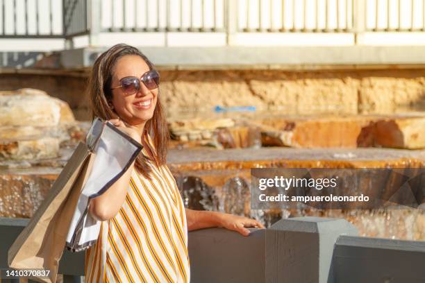 young latin pretty woman shopping in an outlet mall in miami beach, florida, usa - latin american and hispanic shopping bags bildbanksfoton och bilder