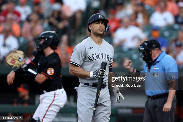 Giancarlo Stanton of the New York Yankees reacts after striking out for the first out of the second inning against the Baltimore Orioles at Oriole...