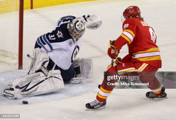 Krys Kolanos of the Calgary Flames is stopped by Ondrej Pavelec of the Winnipeg Jets in third-period NHL action on March 9, 2012 at the Scotiabank...