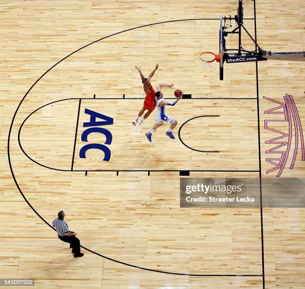 Austin Rivers of the Duke Blue Devils drives to the basket against Jarell Eddie of the Virginia Tech Hokies in their Quarterfinal game of the 2012...