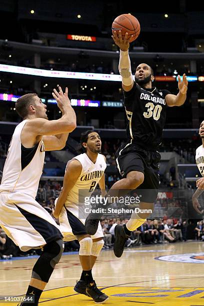 Carlon Brown of the Colorado Buffaloes goes up for a shot over Harper Kamp of the California Golden Bears in the first half in the semifinals of the...