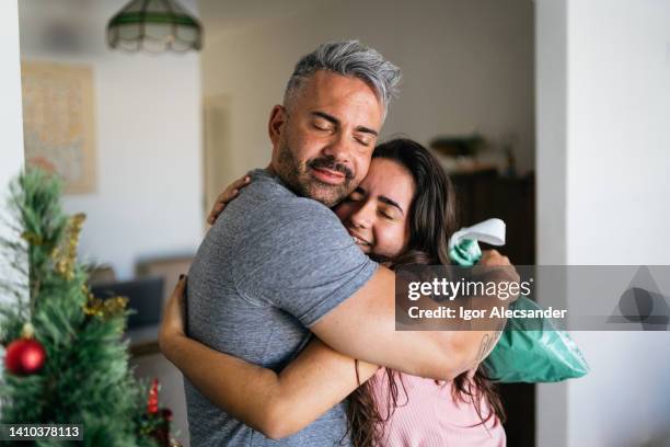 father and daughter hug each other at christmas - papa noel stockfoto's en -beelden