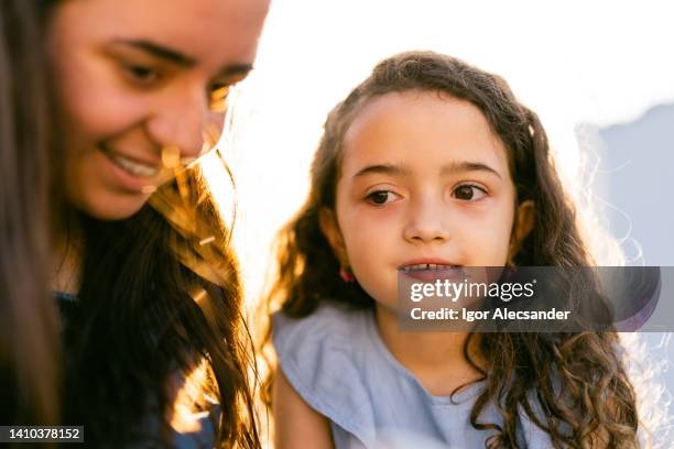 thoughtful little girl and sister - real people family portraits stockfoto's en -beelden