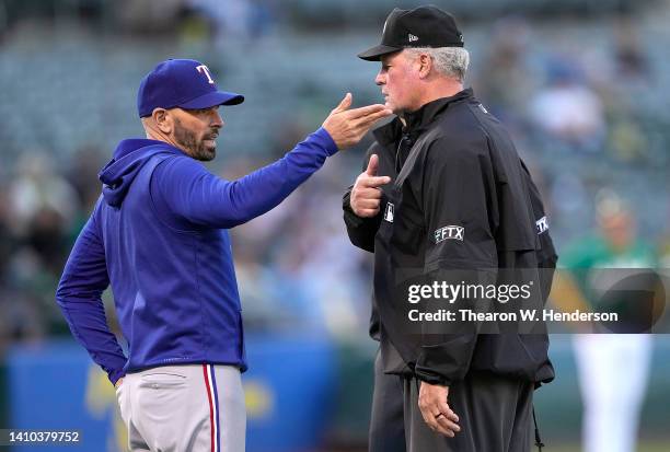 Manager Chris Woodward of the Texas Rangers challenges a call with first base umpire Ted Barrett in the bottom of the second inning against the...