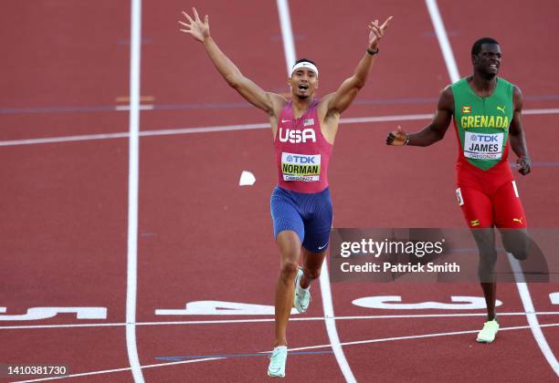 Michael Norman of Team United States and Kirani James of Team Grenada cross the finish line in the Men's 400m Final on day eight of the World...