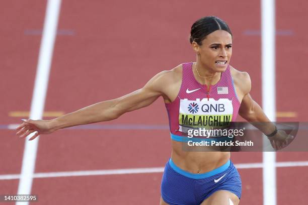 Sydney McLaughlin of Team United States crosses the finish line to win gold and set a new world record in the Women's 400m Hurdles Final on day eight...