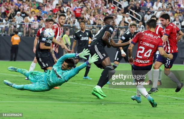 Mattia Perin of Juventus dives to defend a shot by Carlos Cisneros of Chivas during their preseason friendly match at Allegiant Stadium on July 22,...