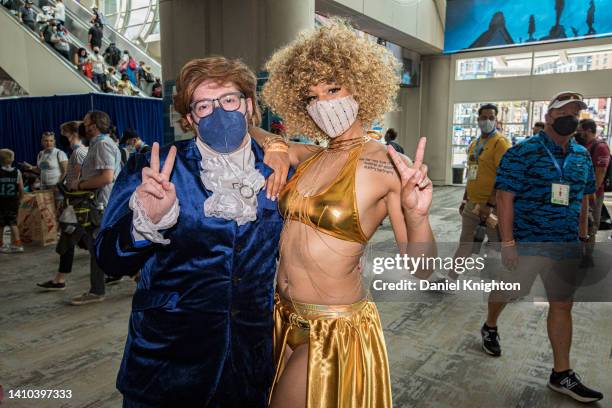 Pair of Austin Powers cosplayers pose for photos at 2022 Comic-Con International Day 2 at San Diego Convention Center on July 22, 2022 in San Diego,...