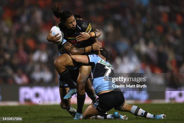 Jarome Luai of the Panthers is tackled during the round 19 NRL match between the Penrith Panthers and the Cronulla Sharks at BlueBet Stadium on July...