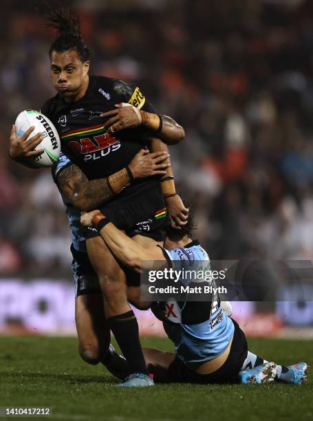 Jarome Luai of the Panthers is tackled during the round 19 NRL match between the Penrith Panthers and the Cronulla Sharks at BlueBet Stadium on July...
