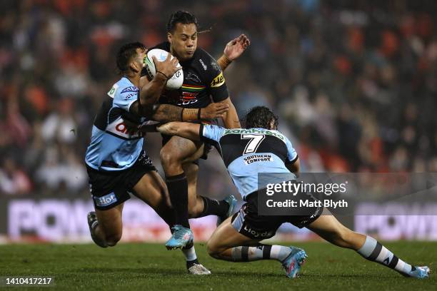 Jarome Luai of the Panthers is tackled during the round 19 NRL match between the Penrith Panthers and the Cronulla Sharks at BlueBet Stadium on July...