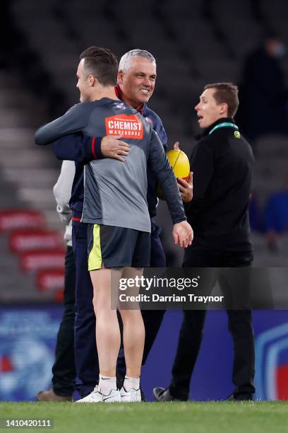 Umpire Jacob Mollison is congratulated on the ground by Mark Williams before his 300th game, the round 19 AFL match between the Western Bulldogs and...