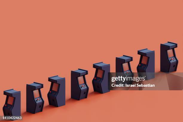 digitally generated image of a group of blue arcade machines lined up on an orange background. - 8 bit game fotografías e imágenes de stock