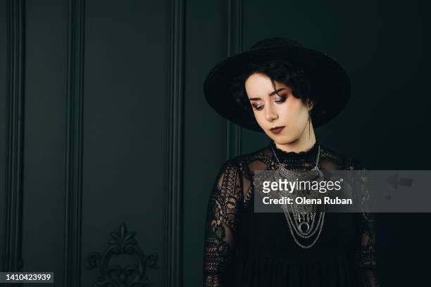 young tender woman in black vintage clothes. - sheer fabric stockfoto's en -beelden
