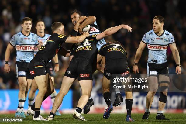 Toby Rudolf of the Sharks is tackled during the round 19 NRL match between the Penrith Panthers and the Cronulla Sharks at BlueBet Stadium on July 23...