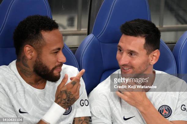 Neymar Jr and Lionel Messi of Paris Saint-Germain talk on the bench prior to the preseason friendly between Paris Saint-Germain and Urawa Red...