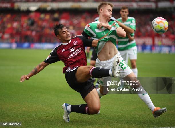 Jens Castrop of 1. FC Nuernberg is challenged by Gian-Luca Itter of SpVgg Greuther Fuerth during the Second Bundesliga match between 1. FC Nürnberg...