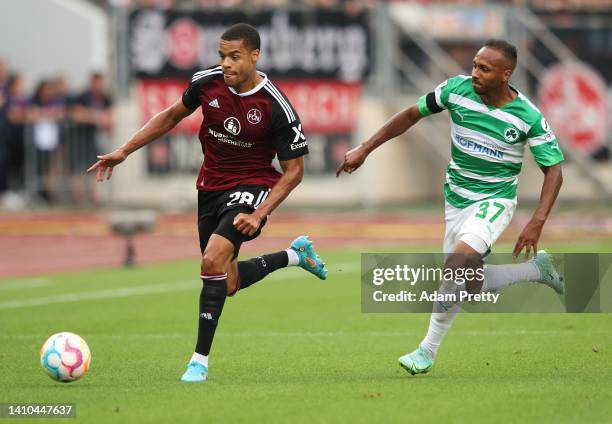 Jan Gyamerah of 1. FC Nuernberg is challenged by Julian Green of SpVgg Greuther Fuerth during the Second Bundesliga match between 1. FC Nürnberg and...