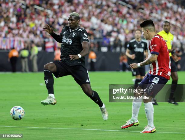 Paul Pogba of Juventus and Pável Pérez of Chivas vie for the ball during their preseason friendly match at Allegiant Stadium on July 22, 2022 in Las...