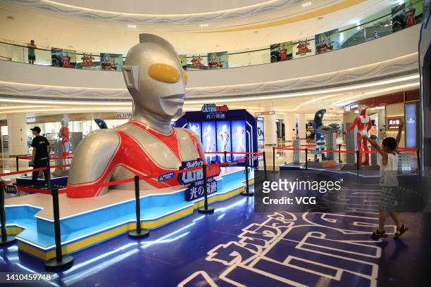 People visit an exhibition featuring characters from the Japanese TV show Ultraman at a shopping mall on July 23, 2022 in Xiangyang, Hubei Province...