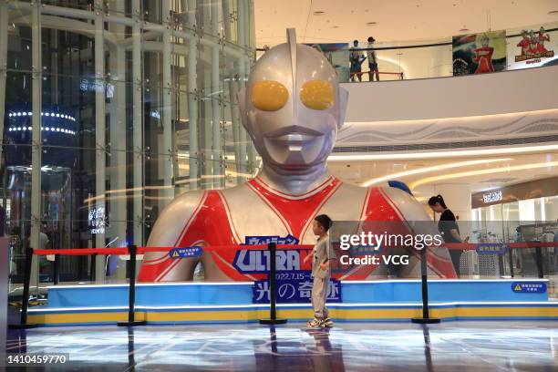 People visit an exhibition featuring characters from the Japanese TV show Ultraman at a shopping mall on July 23, 2022 in Xiangyang, Hubei Province...