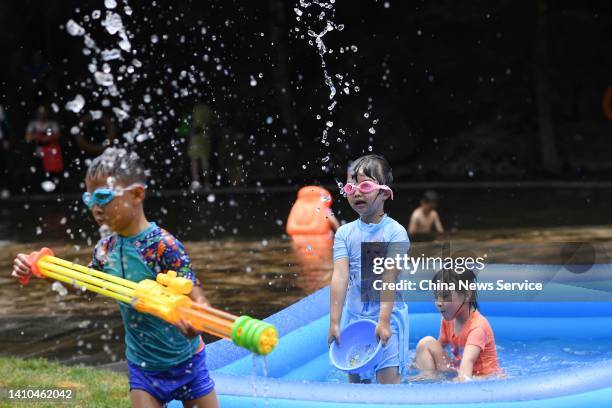 Children cool off at Liuxihe National Forest Park during a hot summer day on July 23, 2022 in Guangzhou, Guangdong Province of China.