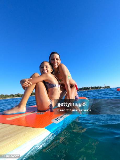 mother and daughter on paddle board - croatia girls stock pictures, royalty-free photos & images