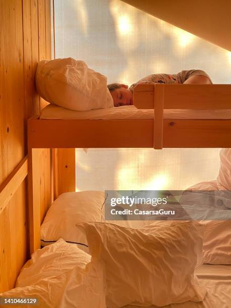 teen girl sleeping in bed inside a glamping tent - kids in bunk bed stock pictures, royalty-free photos & images