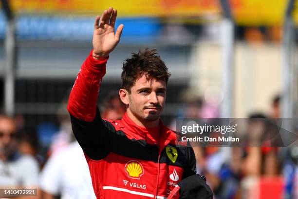 Pole position qualifier Charles Leclerc of Monaco and Ferrari celebrates in parc ferme during qualifying ahead of the F1 Grand Prix of France at...