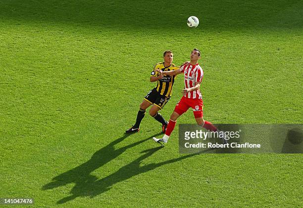 Ben Sigmund of the Phoenix challenges Eli Babalj of the Heart during the round 23 A-League match between the Melbourne Heart and the Wellington...