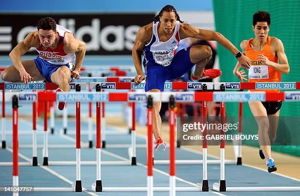 Russia's Konstantin Shabanov, France's Pascal Martinot-Lagarde and Macao's Iong Kim Fai compete in heat 1 during the men's 60m hurdles qualifications...